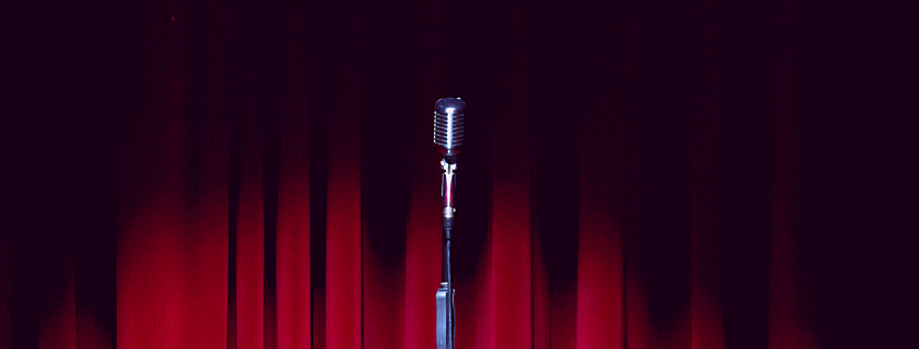 Stage with Microphone and Red Curtains - Auditions