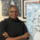 Jeannette-Bradley posing with painting of cotton in a vase---500x500